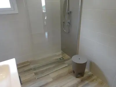 a bathroom with a shower with a toilet and a sink at Residence Monte Cristo in Sainte-Lucie de Porto-Vecchio