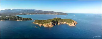 an island in the ocean with a lighthouse on it at Residence Monte Cristo in Sainte-Lucie de Porto-Vecchio