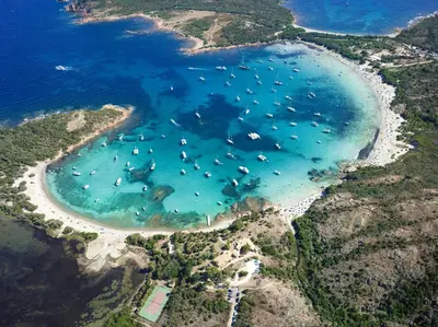 an aerial view of a beach with boats in the water at U Cantu di i Cardellini in Porto-Vecchio