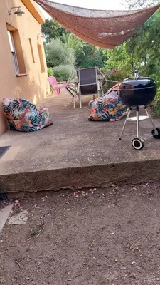 a grill and pillows on the steps of a house at Casapiana in Porto-Vecchio
