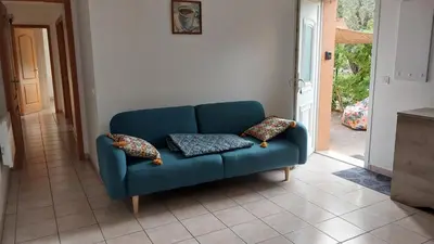 a blue couch in a living room with two pillows at Casapiana in Porto-Vecchio