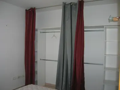 a closet with red curtains and shelves in a room at Casapiana in Porto-Vecchio