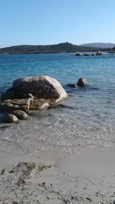 a group of rocks in the water on a beach at Casapiana in Porto-Vecchio