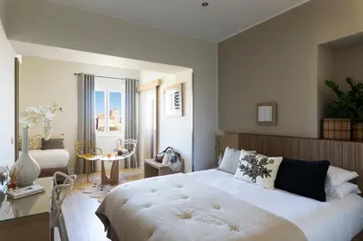 a bedroom with a large bed and a table at Santateresa in Bonifacio