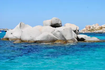 a group of rocks in the blue water at Santateresa in Bonifacio
