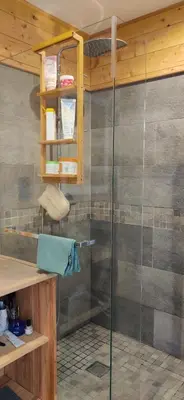 a shower with a glass door in a bathroom at Appartement sur la plage in Ajaccio