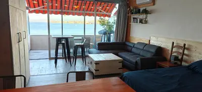 a living room with a couch and a table at Appartement sur la plage in Ajaccio