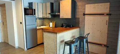 a kitchen with a counter and a refrigerator at Appartement sur la plage in Ajaccio