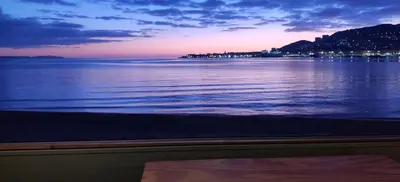a view of a body of water at sunset at Appartement sur la plage in Ajaccio