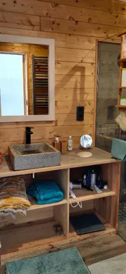 a bathroom with a sink in a wooden cabin at Appartement sur la plage in Ajaccio