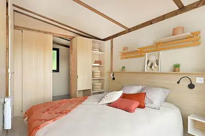 a bedroom with a large white bed with red pillows at PetraLegna in Porto-Vecchio