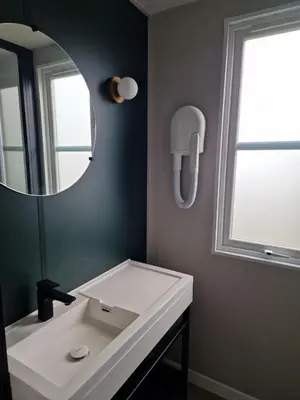 a bathroom with a white sink and a mirror at PetraLegna in Porto-Vecchio