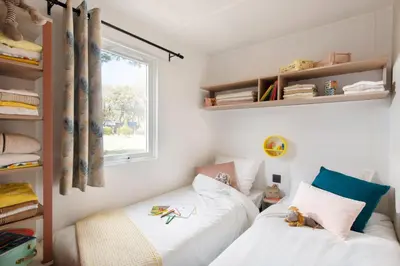 a bedroom with two beds and a window at PetraLegna in Porto-Vecchio