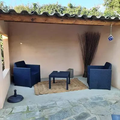 two chairs and a table on a patio at mini villa Marcel classée 3 étoiles in Calenzana