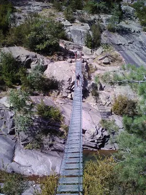 an overhead view of a ladder on a rocky mountain at mini villa Marcel classée 3 étoiles in Calenzana