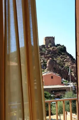 a view of a castle from a window at Hôtel Idéal in Porto Ota