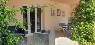 a bedroom with a bed with a wall at Elsanais in Figari