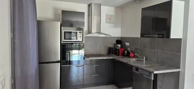 a kitchen and dining room with a table and chairs at Elsanais in Figari