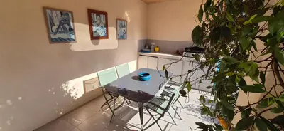 a patio with chairs and a table in a house at Elsanais in Figari