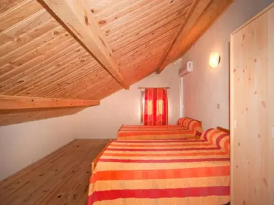 a room with four beds and a red window at Résidence Cabanaccia in Serriera