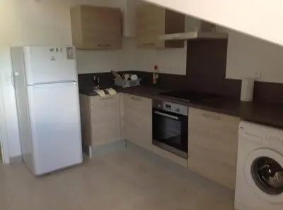 a kitchen with a white refrigerator and a dishwasher at Le Marina 2 in Propriano