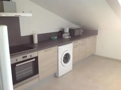 a kitchen with a washing machine and a washer at Le Marina 2 in Propriano