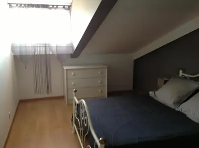 a bedroom with a bed and a dresser and a window at Le Marina 2 in Propriano