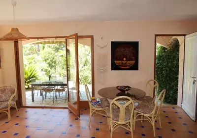 a dining room with a table and chairs at Andre in Porto-Vecchio