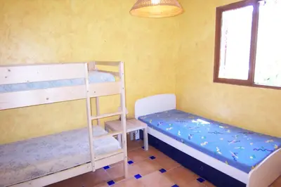 a room with two bunk beds and a window at Andre in Porto-Vecchio