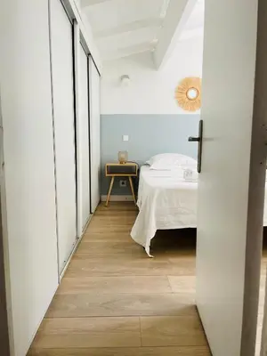 a bedroom with a bed and a table in a room at Propriété Malva appartement margherita in Alata