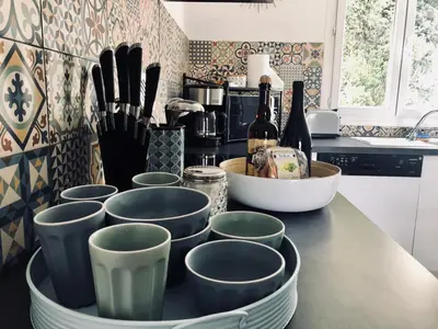 a kitchen counter with a bunch of cups on it at Propriété Malva appartement margherita in Alata