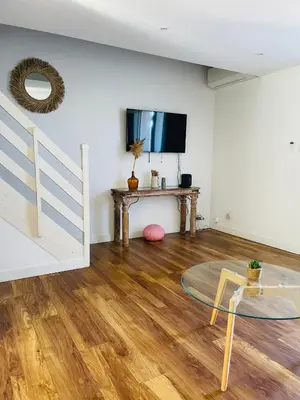 a living room with a table and a tv at Propriété Malva appartement margherita in Alata
