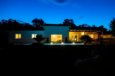 a house at night with the lights on at Villa ARCA in Porto-Vecchio