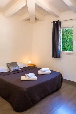 a bedroom with two beds with towels on them at Villa ARCA in Porto-Vecchio