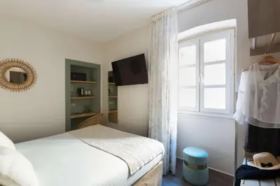 a bedroom with a bed and a window at Best Western Hotel du Roy d'Aragon in Bonifacio