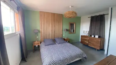 a bedroom with a bed with two blue pillows at Maison porto vecchio - lecci in Porto-Vecchio