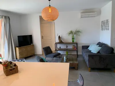 a living room with a couch and a tv at Maison porto vecchio - lecci in Porto-Vecchio