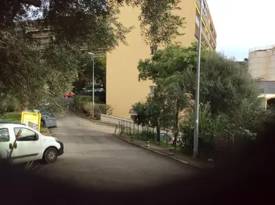 a white car parked on the side of a street at Pietralba Saint Joseph in Ajaccio