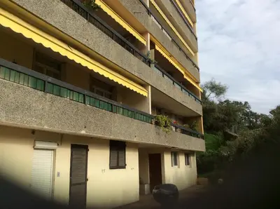 an apartment building with a balcony with plants on it at Pietralba Saint Joseph in Ajaccio