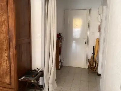 a hallway with a door and a table in a room at Pietralba Saint Joseph in Ajaccio