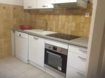 a small kitchen with a sink and a stove at Pietralba Saint Joseph in Ajaccio