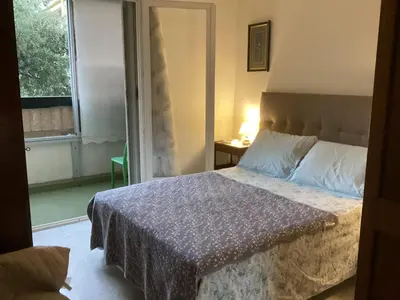 a bedroom with a bed and a window at Pietralba Saint Joseph in Ajaccio