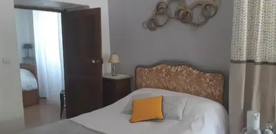 a bedroom with a bed with a orange pillow on it at Casa san salvadore in Favalello