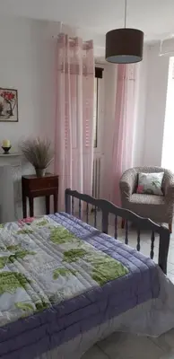 a bedroom with a bed and a chair at Casa san salvadore in Favalello