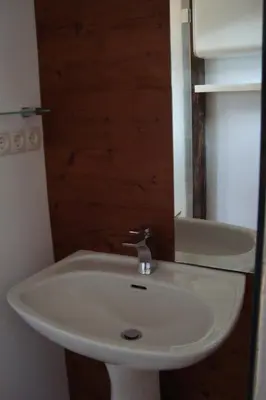 a bathroom with a white sink and a tub at Rustica in Prunete