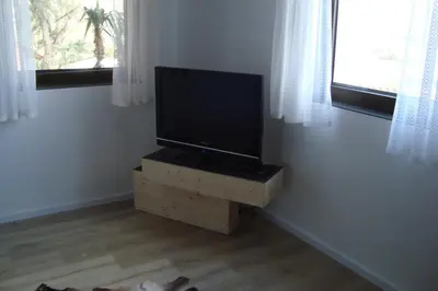 a flat screen tv sitting on a wooden stand in a room at Rustica in Prunete