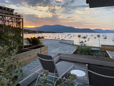 a balcony with a view of the water and boats at Residence Capriona in Porto Pollo