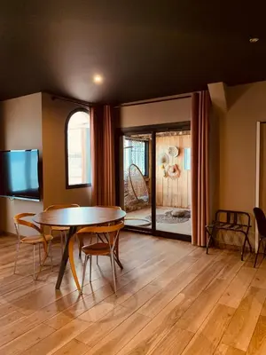 a dining room with a table and a tv at Palm Beach in Ajaccio