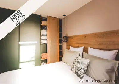 a bedroom with a bed with white pillows at Camping Mulinacciu in Lecci