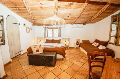 a bedroom with two beds and a couch in it at Ranch Campo Palombaggia in Porto-Vecchio